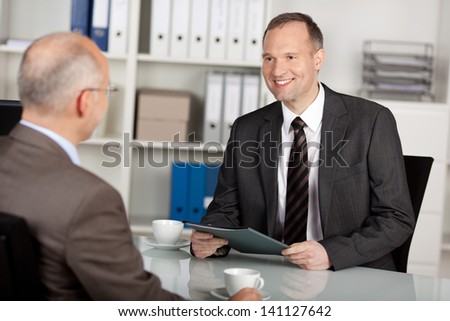 Two Businessmen Having Conversation Inside The Office