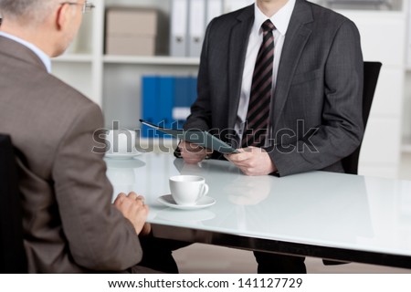 Manager interviewing a male applicant in his office