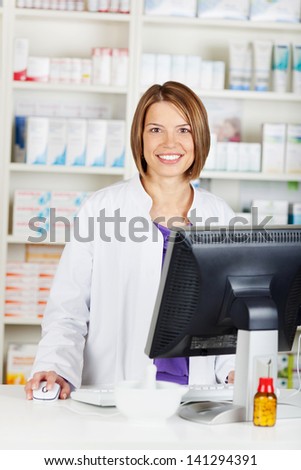 Smiling Female Pharmacist Chemist Working Inside The Drugstore