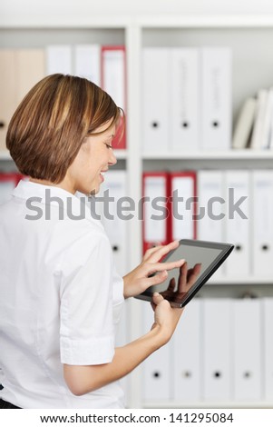 Brunette woman searching something using digital tablet