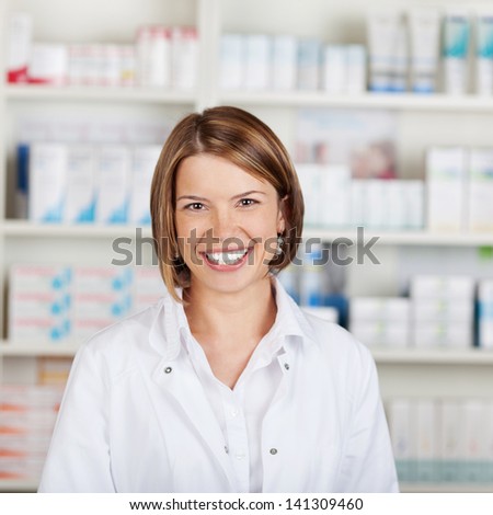 Portrait of a smiling female pharmacist with a beautiful big smile standing in her pharmacy Portrait of a smiling female pharmacist with a beautiful big smile standing in her pharmacy