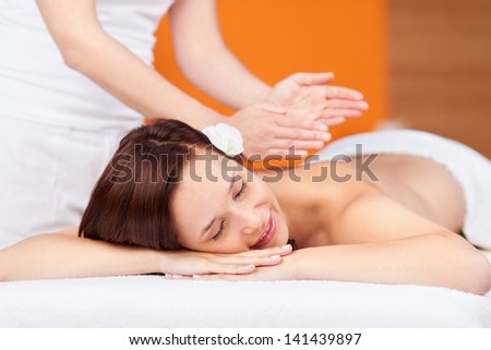 Attractive female is getting a relaxing back massage