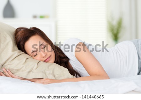 Portrait of beautiful woman sleeping on bed at home