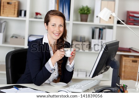 Woman Executive Drinking Coffee at work station