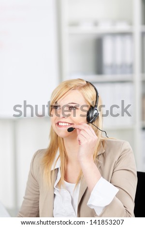 portrait of a smiling costumer service executive using headset