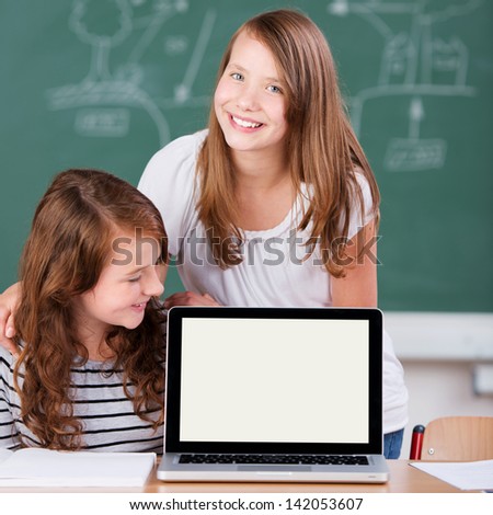 Two Elementary students studying with computer inside the school