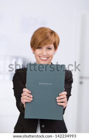 Young businesswoman with a curriculum vitae in her arms, looking for a job