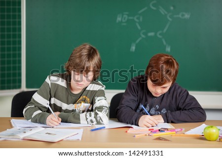 Two male pupils studying their lessons at the classroom