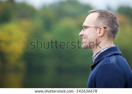 Side view of confident mature man smiling