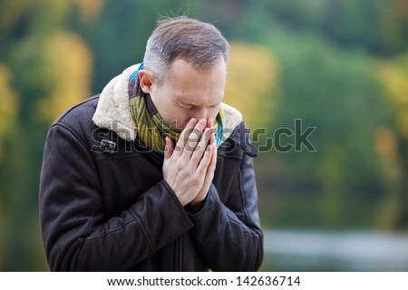 Mature man in jacket suffering from cold