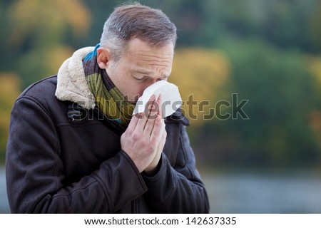 Mature man wearing jacket suffering from cold