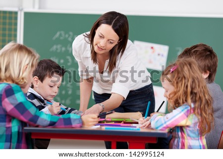 Teacher explain something to her students in art class