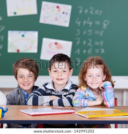 Three children sitting and studying inside the classroom
