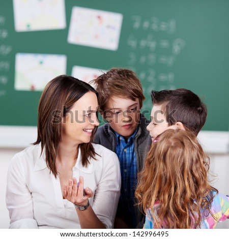 Portrait of schoolchildren listening on their teacher in science class