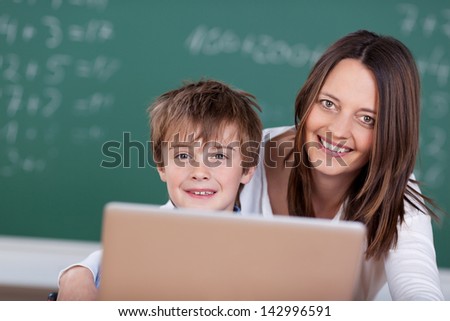 Happy teacher guide her student to learn from laptop