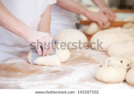 Bakers Making Handmade Loaves Of Bread In A Family Bakery Shaping The Dough Into Tradional Shapes