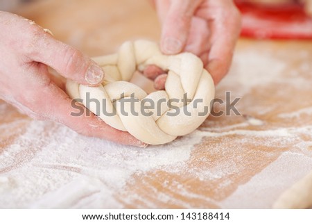 A braided ring of yeast cake before baking