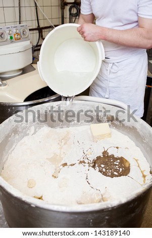 A baker at work in the bakery, making dough