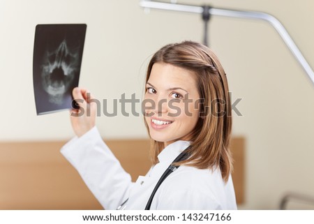 Beautiful doctor examining the x-ray inside the lab