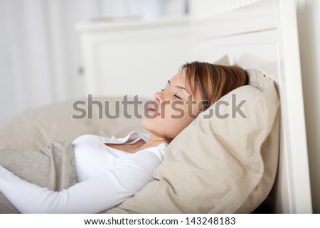 Photo of a woman taking a nap in the bed.