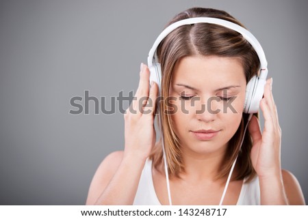 Eyes closed female listening music through headphone