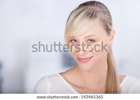 Head and shoulder shot of smiling casual female in a close up shot