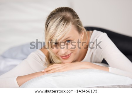 Attractive young woman relaxing in her bedroom