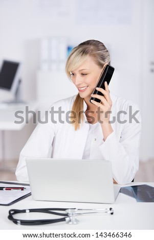Smiling doctor giving medical advice through telephone