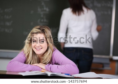 Happy blond student is smiling during class