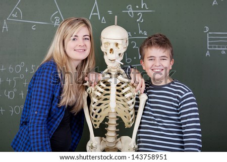 Students are hugging a skeleton during class