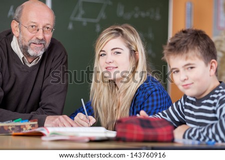 Teacher is helping two students to prepare for a test