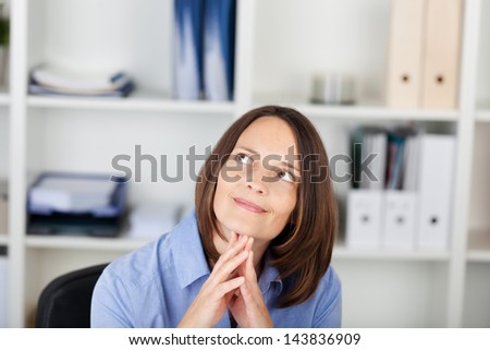 Closeup of thoughtful businesswoman looking up in office