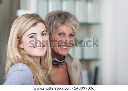 Beautiful happy portrait of a cute teenage granddaughter with her grandma.