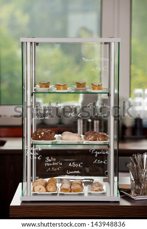Variety of delicious food displayed in cabinet at coffee shop