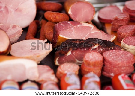 Closeup Of A Variety Of Cooked Meats, Salamis And Sausages At A Delicatessen