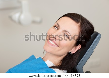 Portrait Of Mid Adult Female Patient Smiling In Dentistry