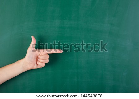 Blackboard and hand making a sign with pointed finger