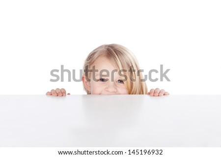 Portrait Of Happy Little Girl Peeking Over Table Isolated Over White Background