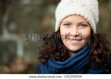 Portrait of beautiful young woman wearing muffler and knitted hat