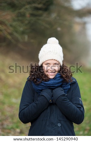 Pretty girl during a winter walk dressed in warm clothes