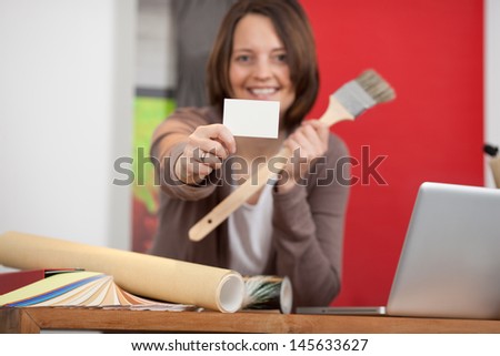 female interior designer showing white card in store