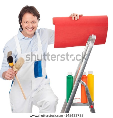 Painter with wallpaper and paints standing on a small metal stepladder in his white overalls smiling at the camera