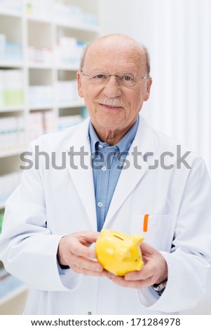 Successful senior pharmacist holding a piggy bank with his savings as he contemplates taking retirement with his nest egg, conceptual image