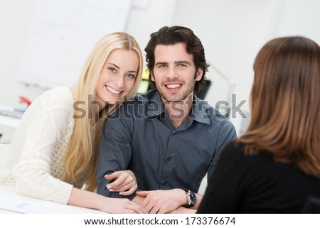 Happy couple embraced in an affectionate way during an interview