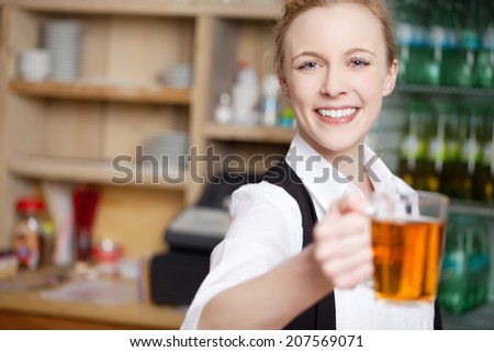 Portrait of happy young waitress holding coffee cup in cafe
