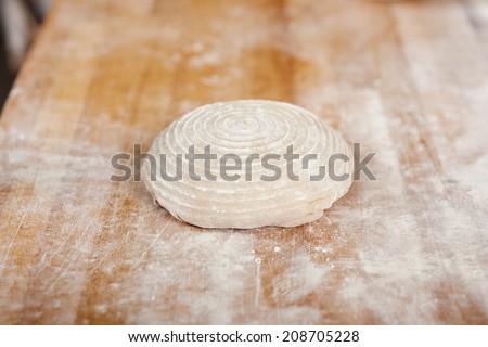 dough lying on wooden table at bakery