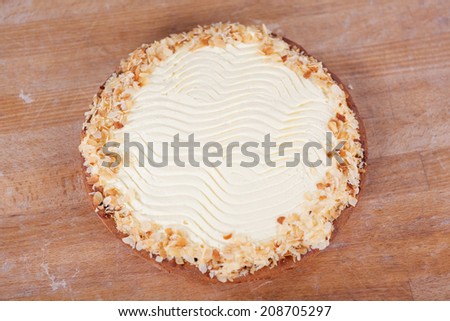 High angle view of cream pie on wooden table at bakery