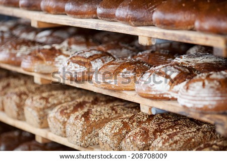 Variety of delicious breads displayed on shelves in bakery