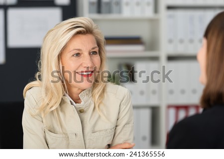 Close up Smiling Blond Attractive Office Woman Talking to her Assistant Employee at her Office.