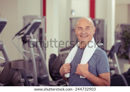 Close up Smiling Old Man, with Towel at his Shoulder, at the Fitness Gym. Looking at the Camera